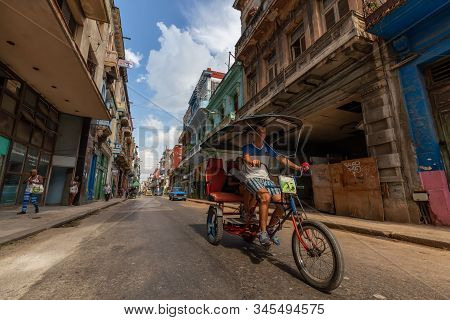 Havana, Cuba - May 14, 2019: Bicycle Taxi Driver Riding In The Streets Of Old Havana City During A V