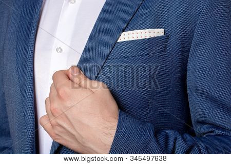 Male Hand Of Businessman Holding The Edge Of His Classic Blue Blazer