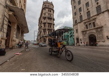 Havana, Cuba - May 14, 2019: Bicycle Taxi Driver Riding In The Streets Of Old Havana City During A C