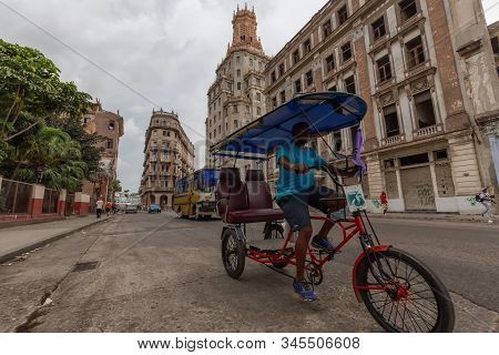 Havana, Cuba - May 14, 2019: Bicycle Taxi Driver Riding In The Streets Of Old Havana City During A C