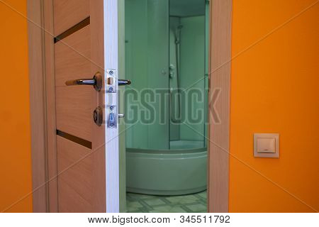 Ajar Door To The Bathroom With Shower. The Problem Of Privacy. Close-up