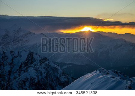 A beautiful view of a sunrise and snow capped mountains in himalaya from the summit of a himalayan m