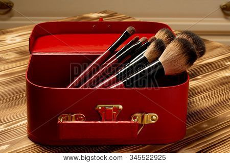 Beauty Red Box With Set Of Red Makeup Brushes On Wooden Background