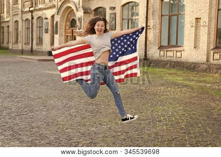 Being Free And Live Life Fully. Happy Girl Jumping Free With American Flag Outdoor. Sensual Woman Ce