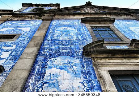 Oporto, Portugal- January 2, 2020: Beautiful And Old Tiled Facade Of Capela Das Almas Church In Opor