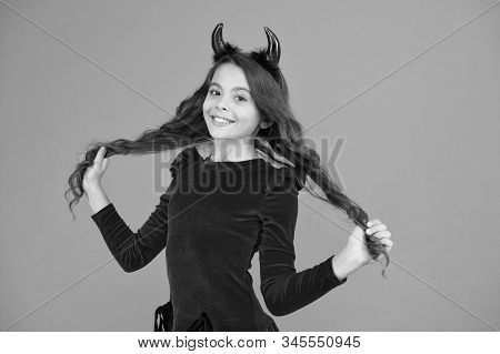Beautiful Small Imp. Girl Red Horns Celebrate Halloween. Carnival Concept. Small Child With Imp Styl