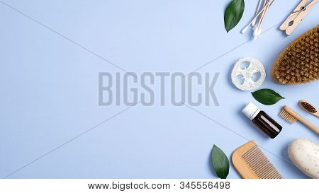 Zero Waste Bathroom Accessories On Blue Background. Flat Lay Bamboo Toothbrushes, Wooden Hair Comb, 