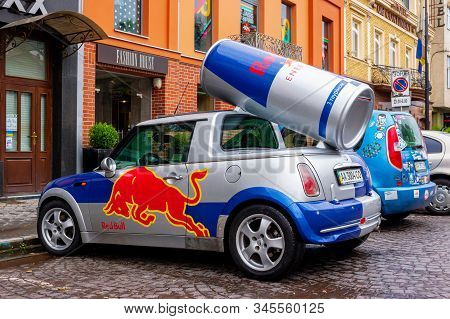 Uzhhorod, Ukraine - 14 Jul, 2013: Red Bull Mini Cooper Publicity Car With A Can Of Energy Drink Behi