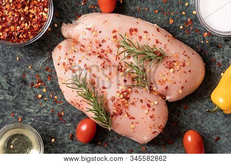 Raw Chicken Breast With Rosemary, Vegetables  And Red Pepper On Green Marble Cutting Board. Top View