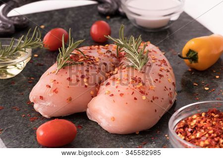 Raw Chicken Breast With Rosemary, Vegetables  And Red Pepper On Green Marble Cutting Board. Chickenb