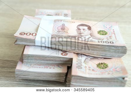 Stack Thai Baht Banknotes, One Thousand Baht With Tag Text In Thai Word. (thb) Is Official Currency 