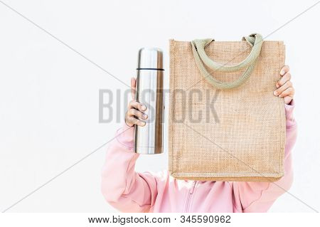 An Asian Girl Is Using A Cloth Bag In Place Of A Plastic Bag In The Concept Of Reducing Plastic Wast