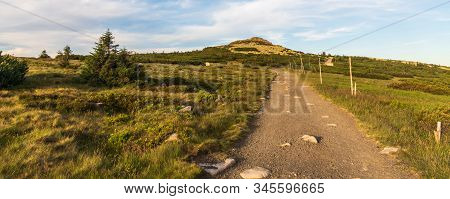 Rocky Violik Hill With Hiking Trail And Building On Snezne Jamy On The Background In Evening Krkonos