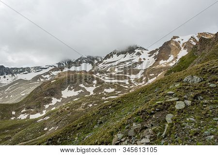 Spectacular Mountain Panorama With Clouds Covering The Sky.
