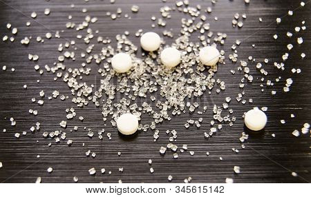 Sweetener Tablets Lying With Sugar On A Dark Background