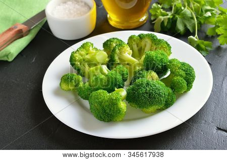 Vegetarian Food. Broccoli On White Plate On A Dark Surface