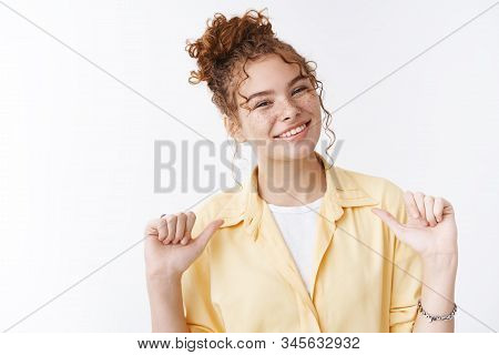 Smiling Friendly-looking Confident Female Ginger Messy Hair Bun Curly Haircut Freckles Pointing Hers