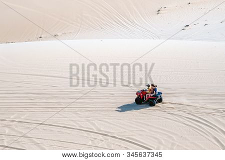 Mui Ne-vietnam-april 24, 2019: Unidentified Tourists Enjoy Riding The Quad Bike Or Powerful Fast Off