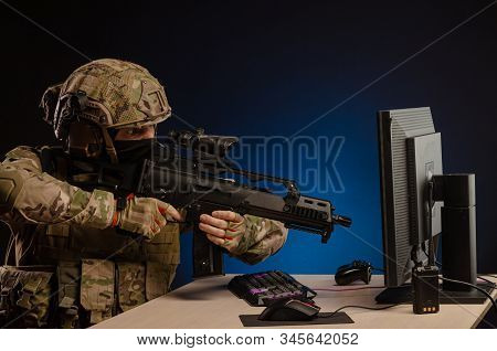 Military In Uniform Sitting At A Computer Conducts Cyber Warfare