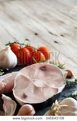 Two Shark Steak With Vegetables And Herbs On A Wooden Table