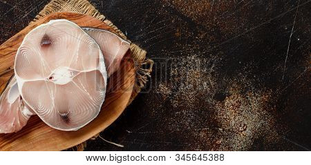 Two Shark Steak On A Dark Board Top View