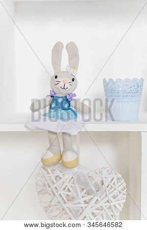 Cute Rabbit Doll On The Shelf In Kids Room. Easter Decoration. Shelves With Soft Toys Rabbits In The