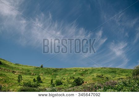 Summer View Of The Plateau Lago Naki With Snow. Beautiful Clouds And Mountain In A Blue Haze.