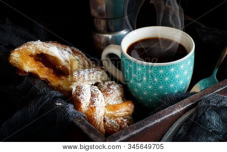 Cup Of Coffee With Croissant On A Dark Background Close Up