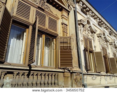 Beautiful Facade Of An Old Building In Serbia. Wooden Shutters Give The House A Special Charm. Windo