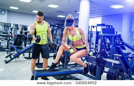 Trainer And Client At The Gym With Sport Equipment. Young And Fit. Healthy Fitness Life Concept. Nic