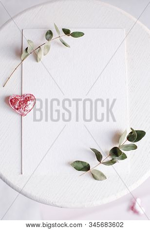 Background With Copy Space Blank On White Table With Glitter Heart, Eucalyptus Branch, Flowers And L