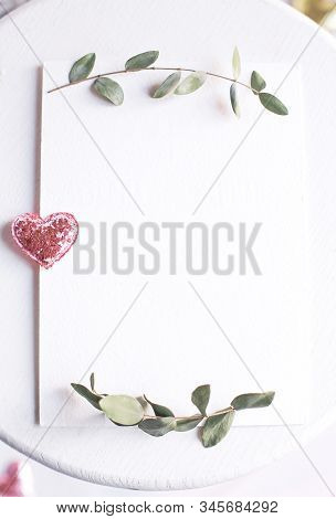 Background With Copy Space Blank On White Table With Glitter Heart, Eucalyptus Branch, Flowers And L