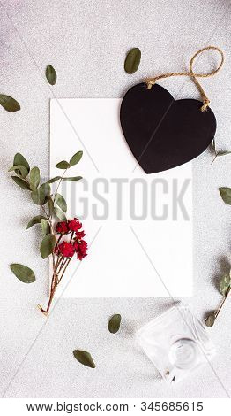 Background With Copy Space Blank On Table With Black Heart, Eucalyptus Branch, Roses Flowers And Lea