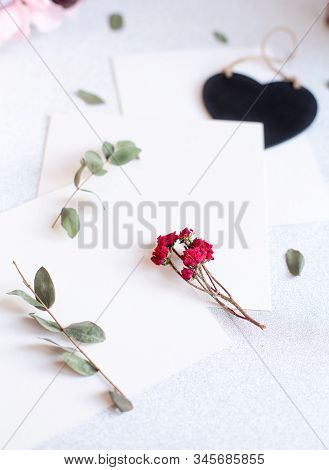 Background With Copy Space Blank On Table With Black Heart, Eucalyptus Branch, Roses Flowers And Lea