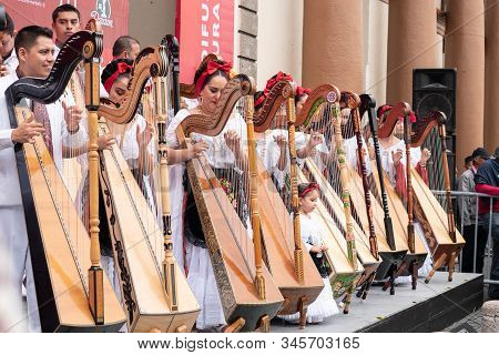 Xalapa, Veracruz, Mexico- November 24, 2019: Musicians Playing The Harp, Dressed With Traditional Cl