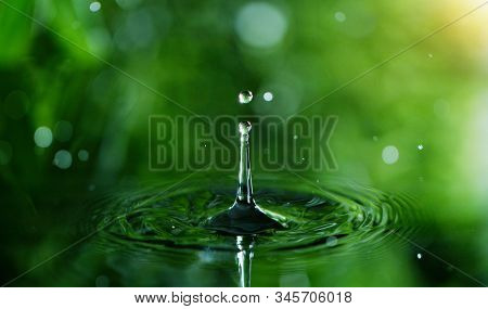 Dropping water in detail, spa and wellness concept. Shot on super macro lens, low depth of focus. Free space for text.