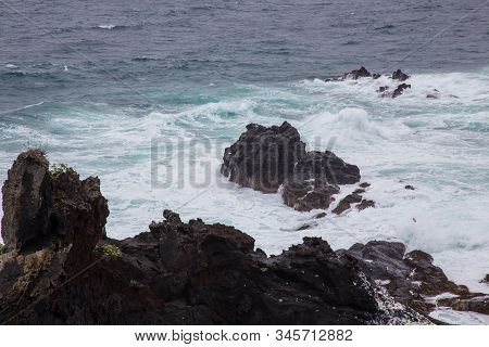 Beautiful Nature Scene Of Sea Wave Hitting On The Black Stone Shoreline At Jeju Island, South Korea.
