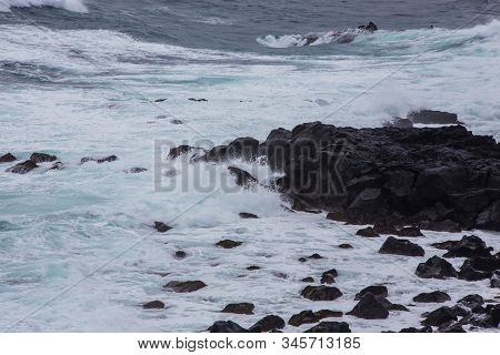Beautiful Nature Scene Of Sea Wave Hitting On The Black Stone Shoreline At Jeju Island, South Korea.