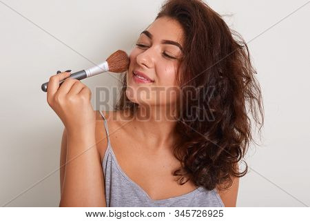 Picture Of Attractive Magnetic Female Standing Isolated Over White Background In Studio, Looking Asi