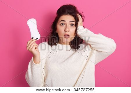 Close Up Portrait Of Surprised Female Holding Hygiene Pad In One Hand, Having Menstruation, Having S