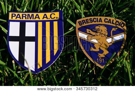 September 6, 2019, Turin, Italy. Emblems Of Italian Football Clubs Brescia And Parma On The Green Gr