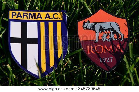 September 6, 2019, Turin, Italy. Emblems Of Italian Football Clubs Parma And Roma On The Green Grass