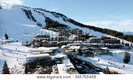 Majestic Winter Aerial Landscape And Ski Resort With Typical Alpine Wooden Houses In French Alps, Le