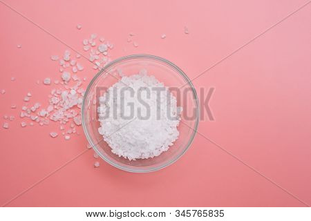 Glass Bowl With Sea Coarse White Salt On A Pink Background. Flat Lay, Copy Space. Spa Concept Or Tem