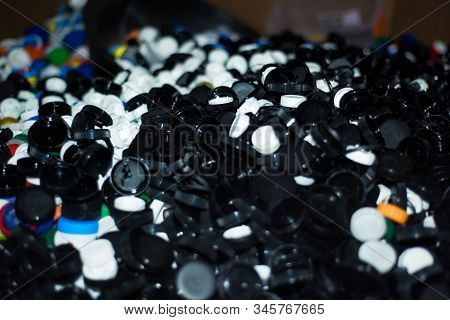 Waste Heap From Plastic Bottle Caps On Waste Sorting Station. Large Pile Of Colored Stoppers Destine