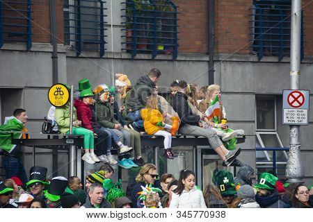 Dublin, Ireland - March 17, 2019 Children With Faces Painted In The Colors Of The Irish Flag Sit On