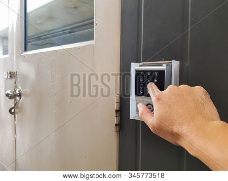 Selective Focus Of Men Hand Reaching To Enter Pass Code To Access The Area. In Building Security Or 