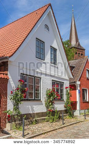 White House With Red Flowers In Plon, Germany
