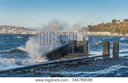 Waves Crash Onto The Shore At Alki Beach In West Seattle, Washington.