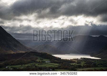 Epic Sun Beams Light Up Crummock Water In Dramatic Autumn Fall Landscape Image With Mellbreak And Gr